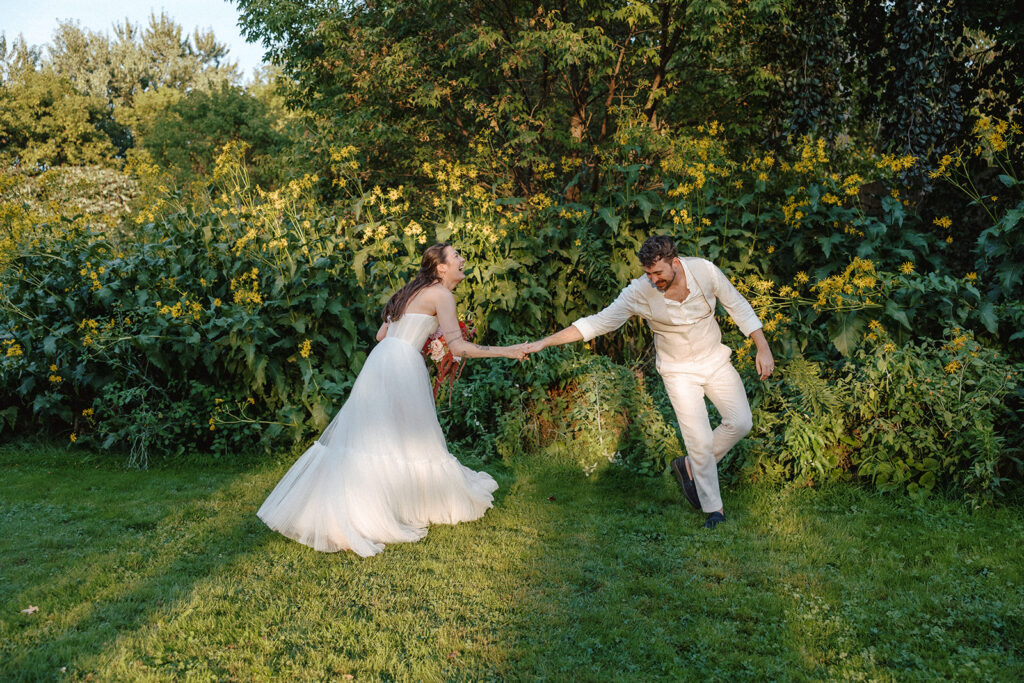 Non-traditional Vermont wedding ceremony at the Intervale Center with friends and family gathered outdoors.