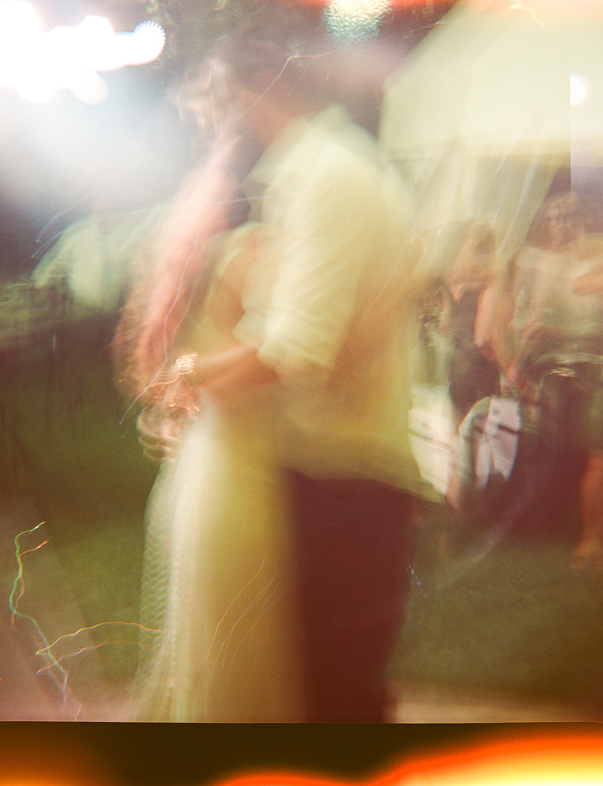 colorful blurry photo taken on holga camera of bride and groom dancing