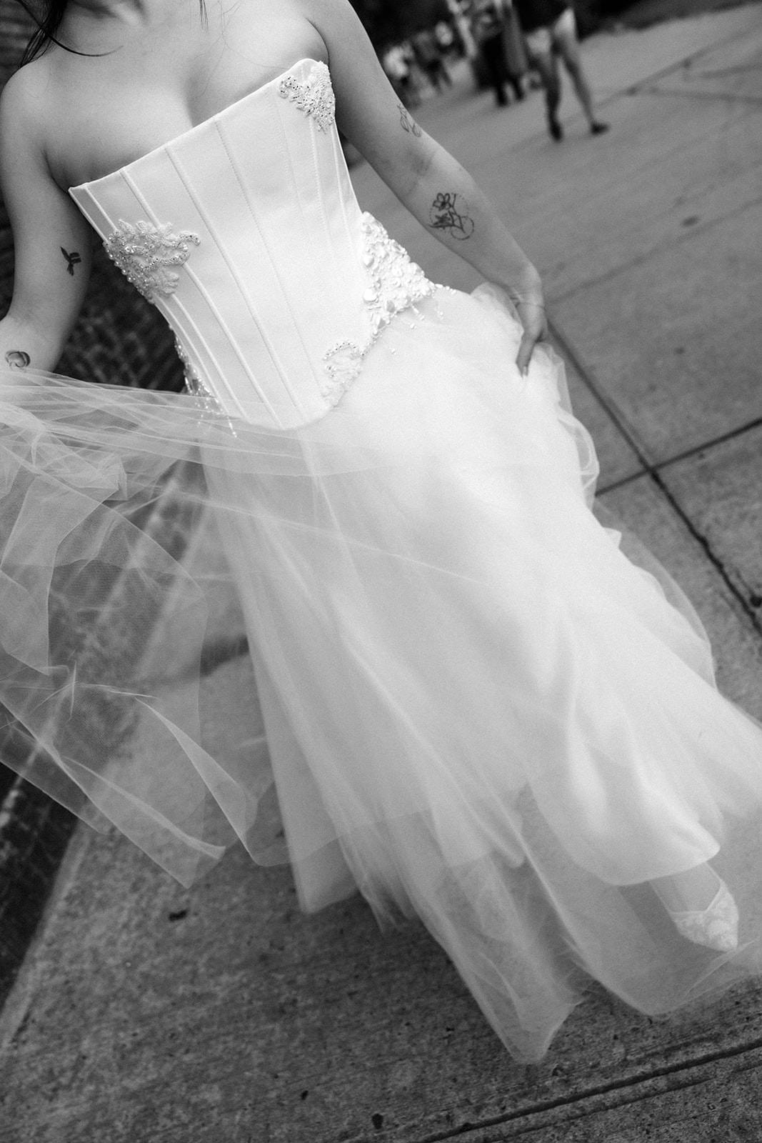 black and white detail photo of bride wearing wedding dress on the street in brooklyn new york