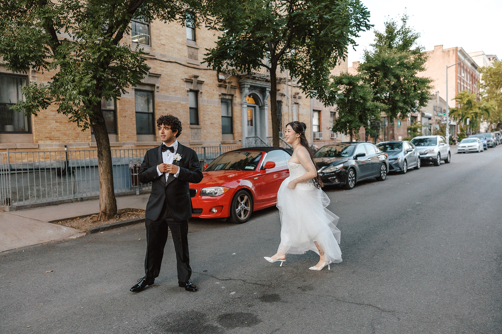 bride and groom walking across a street in brooklyn