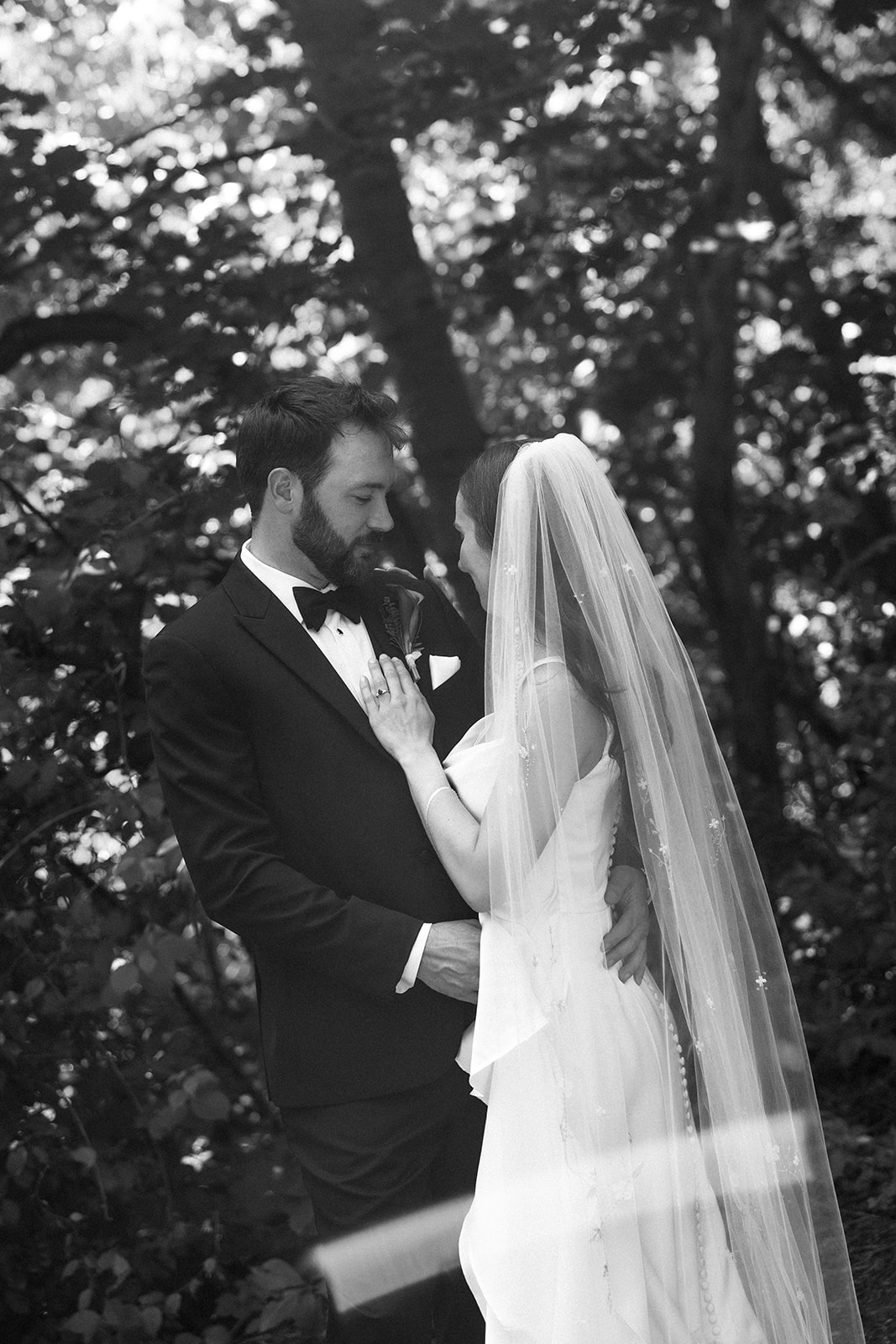 bride and groom having an intimate moment in the forest 