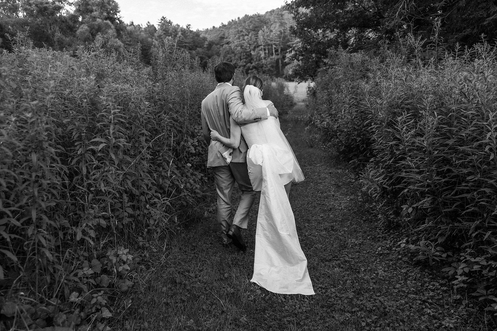 bride and groom walking arm in arm 